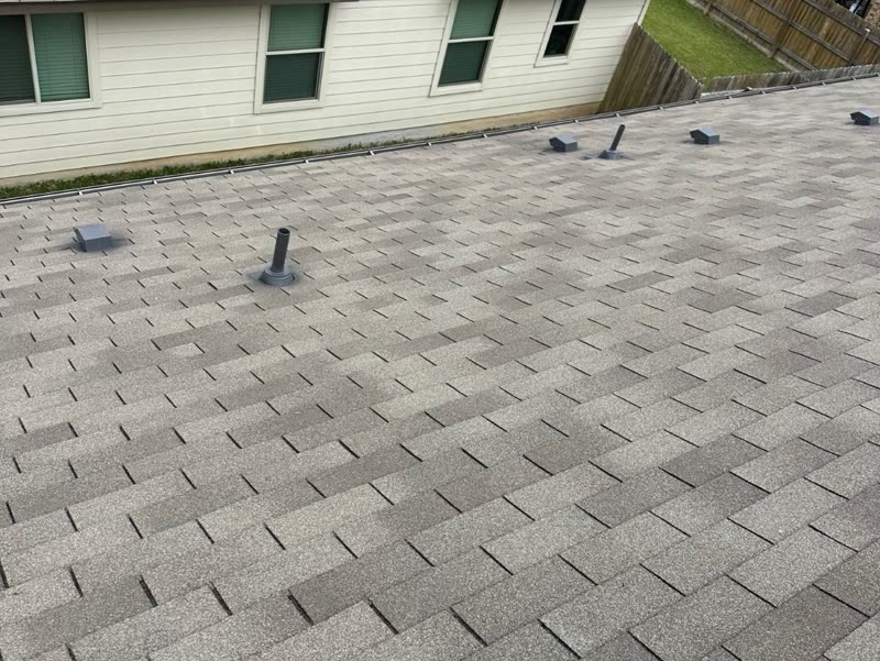Finished shingle replacement on a single-storey home, with vents and flashing set.